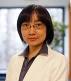 A person standing in front of a windowDescription automatically generated